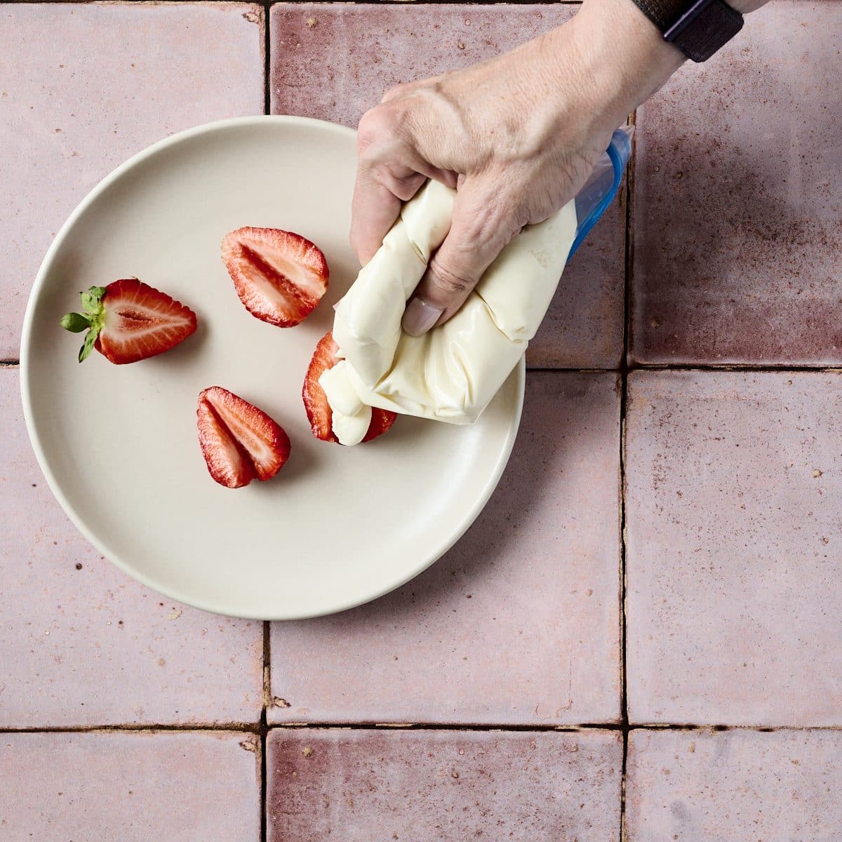 Filling strawberries with no bake cheesecake mixture