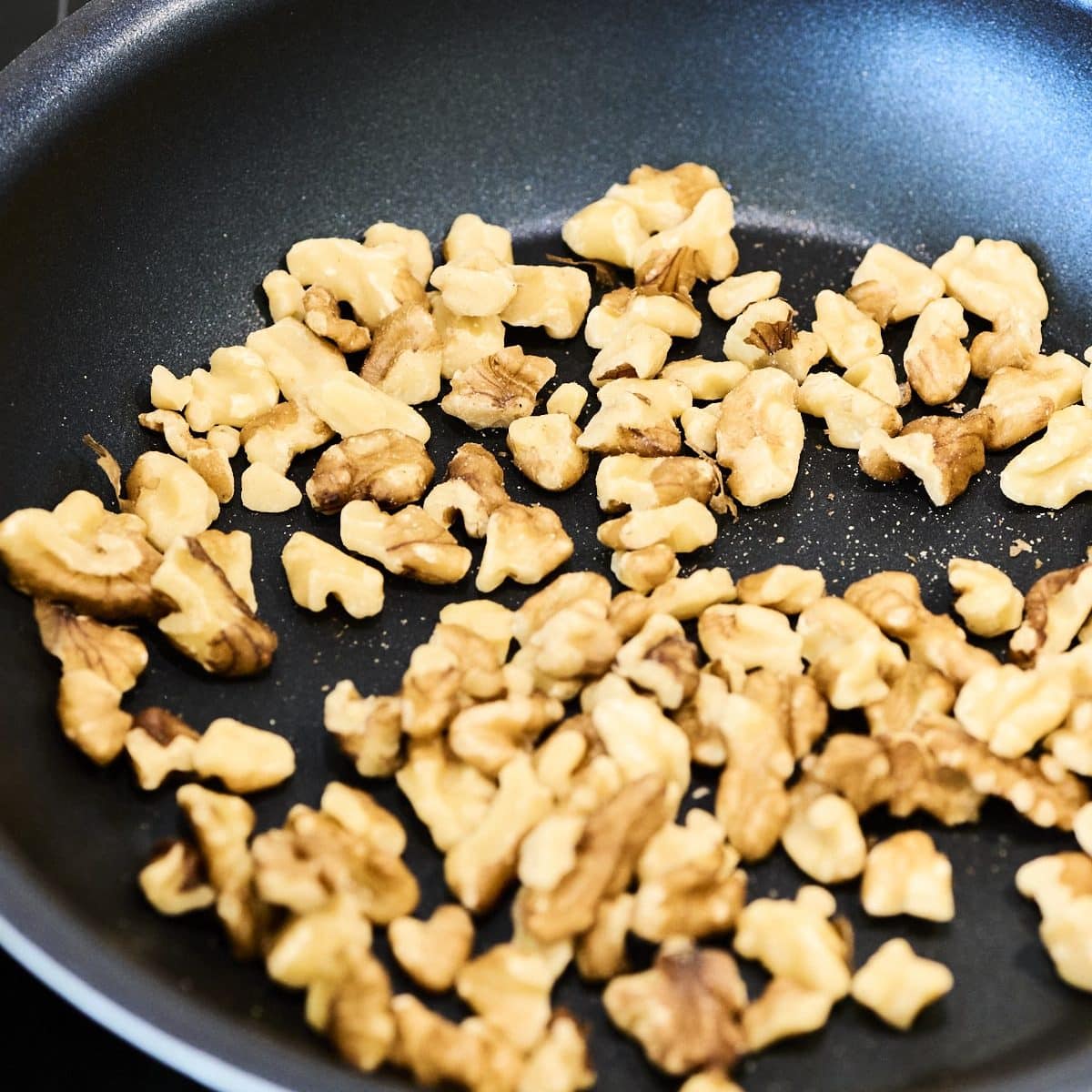 Walnuts toasting in a pan